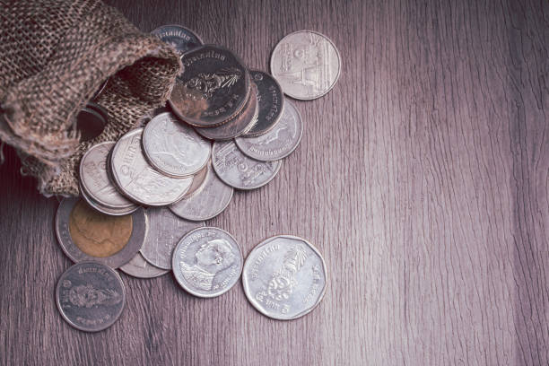 istock Coins in bags piled on the floor. Money saving concept. 1404674702
