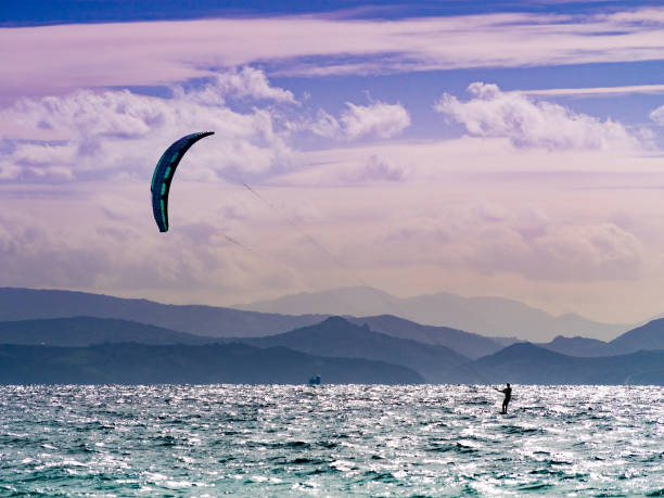 Kiteboarding. Kite surfer rides waves, Tarifa, Cadiz in Spain. Sports activity. Kitesurfing action.