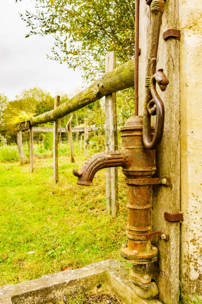 istock Old hand pump in garden 1404675146