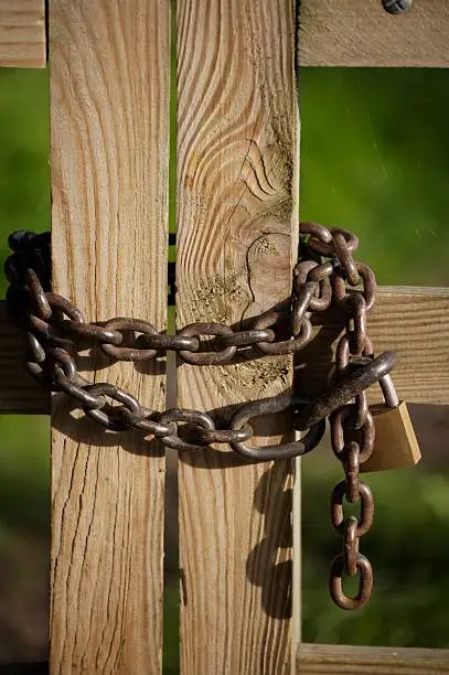 Image showing wooden gate locked with a chain and padlock.