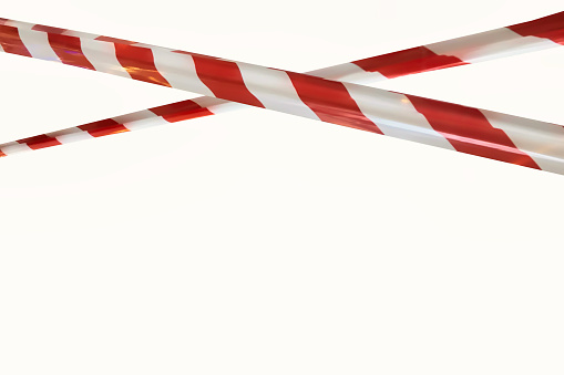 Red white lines of barrier cross tape prohibit passage, on white isolate background. Barrier that prohibits traffic. Danger unsafe area warning tape do not enter. Concept no entry. Copy space