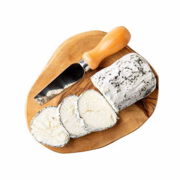 Buche de Chevre with ash. Soft goat cheese on wooden board isolated on white background. Top view. Buche de Chevre with ash. Soft goat cheese on wooden board isolated on white background. Top view. cheese goat cheese gourmet food stock pictures, royalty-free photos & images