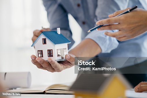 istock Architects who design buildings and houses are explaining examples of houses to project owners regarding house designs in housing projects. Home and interior design ideas by architect engineers. 1404678764
