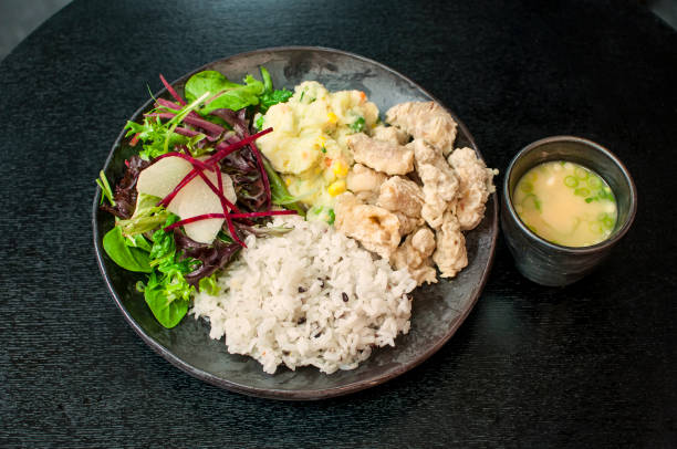 istock Korean Squid Tuigim Dosirak, fried squid tempura bento box with vegetables on rice 1404679280