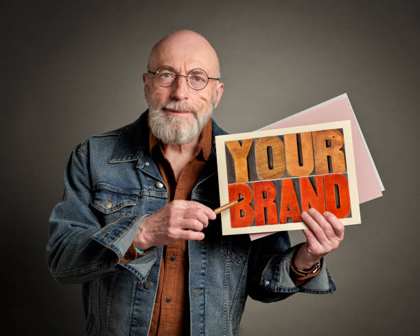 istock senior man with your brand sign 1404680365
