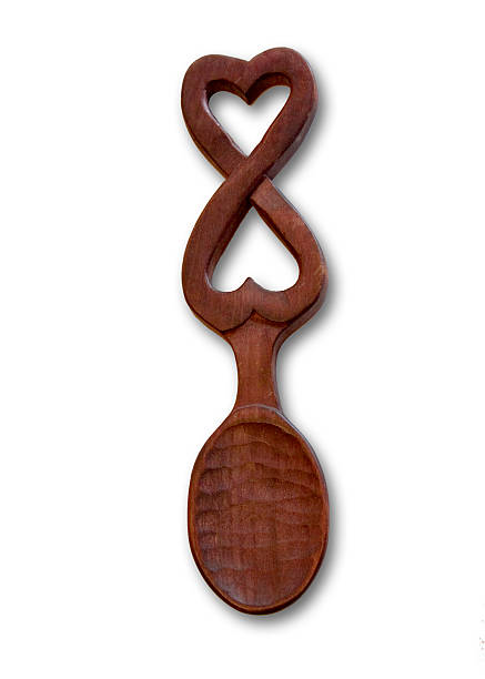 Love Spoon A hand carved Welsh love spoon with two interlocking hearts. welsh culture stock pictures, royalty-free photos & images