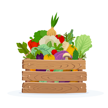 Organic vegetables in wooden crates on white background.