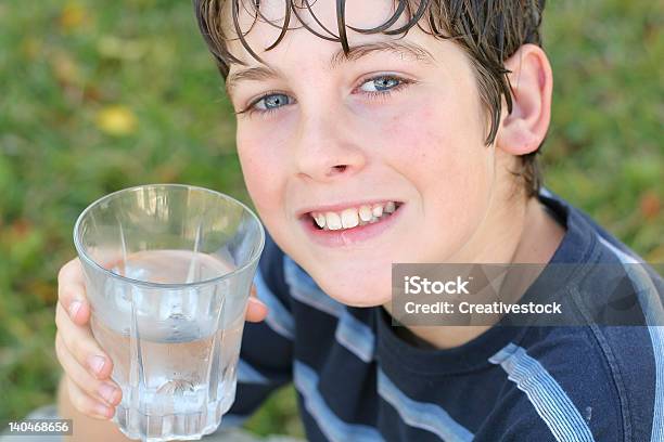 Boy Drinking A Glass Of Water Smile Stock Photo - Download Image Now - Adolescence, Beautiful People, Blue