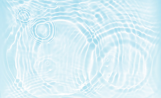 beautiful  abstract water background, water wave and circles with sun reflections from above in white and light blue, clean water texture for cosmetics, beach vacation, pharmacy or  water resource