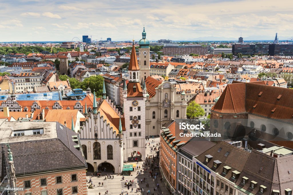 Aerial view of old Town Hall of Munich, Germany Marienplatz and Old Town Hall (Altes Rathaus) of Munich in sunny day. Marienplatz is the most important town square of Munich and is a pedestrian zone. Tourists and locals stroll in the square in front of the ancient monument. Munich Stock Photo