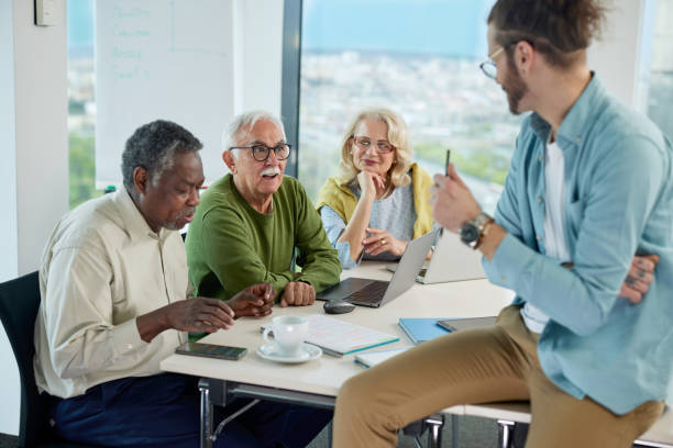 istock A young teacher asks a small group of multiracial senior students questions about digital marketing in a classroom. 1404693507