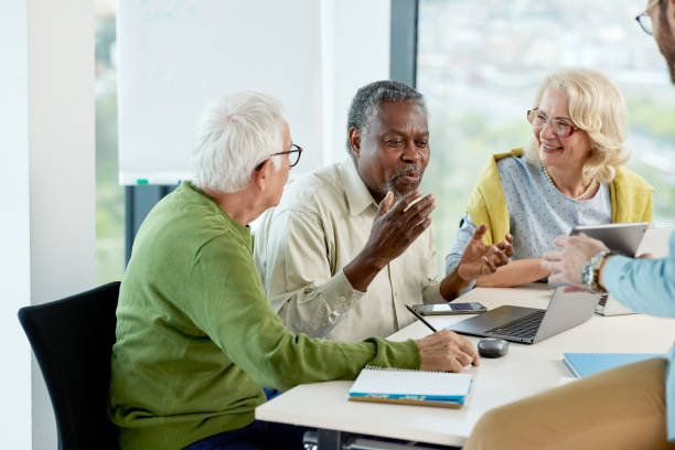 istock Multicultural group of senior students asking questions their tutor who showing them solution. 1404693841