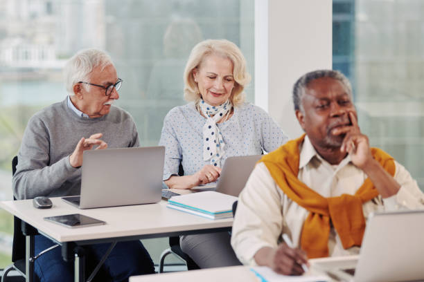istock Senior students following lecture in a classroom. 1404693924