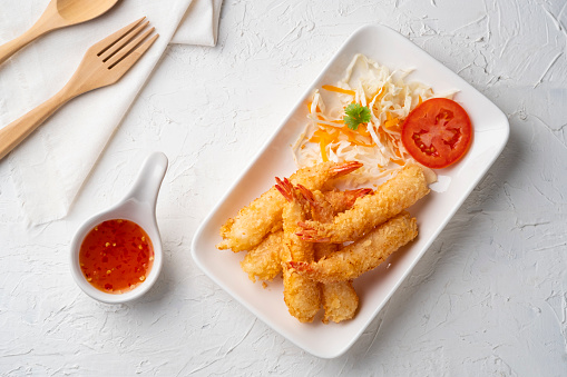 Crispy fried shrimp.Deep fry shrimp with Breadcrumbs on white plate with chilli sweet sauce.Top view