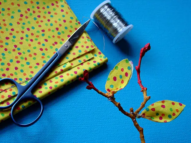             Fabric,scissors,metal thread,branch.                   