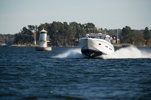 Motor boat and lighthouse in the archipelago