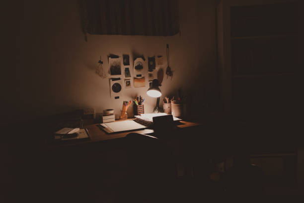 istock sad messy desk with spotlight at night 1404697391