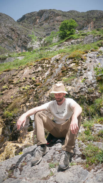 istock White man sitting in a meadow 1404698531