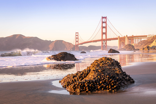 The Golden Gate Bridge at sunset as seen from Baker Beach in San Francisco, California