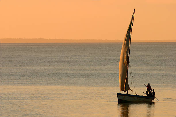 Mozambican dhow at sunset Traditional sail boat called a dhow at sunset, Vilanculos coastal sanctuary, Mozambique, southern Africa mozambique stock pictures, royalty-free photos & images