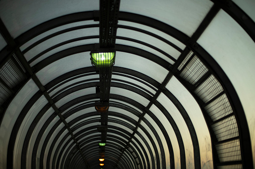 Tunnel in evening. Lamps in pedestrian crossing. Architecture details. Row of lamps in tunnel.