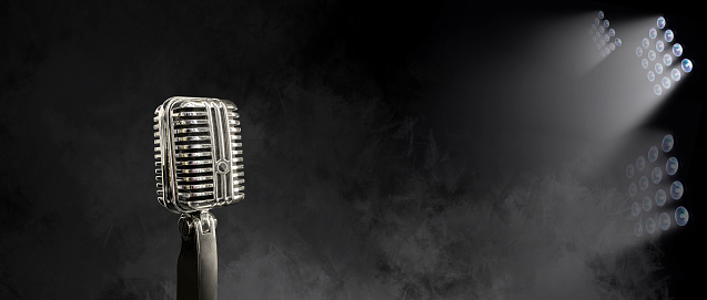 Retro microphone on dark color background with copy space