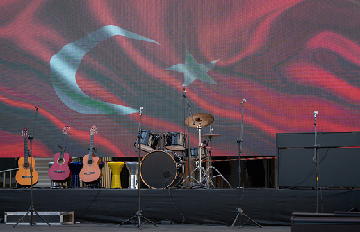 Turkish flag on the led screen and music equipment ready to perform on the stage.