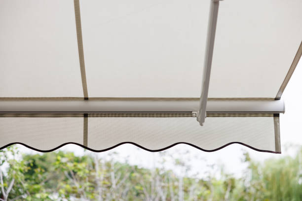 istock white fabric awning with the garden background. white canvas sun shading roof. 1404703870