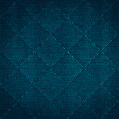 Dark blue colored seamless natural cotton linen textile fabric texture pattern, with diamond quilted, rhombic stiching.  stitched background square
