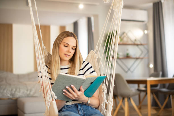istock Woman relaxing and reading a book 1404705900