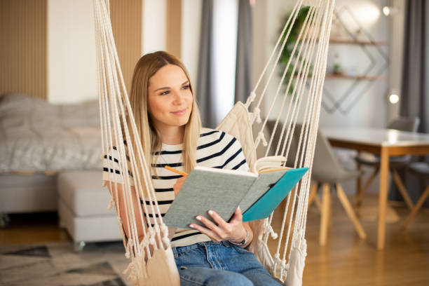 istock Woman relaxing and reading a book 1404705910