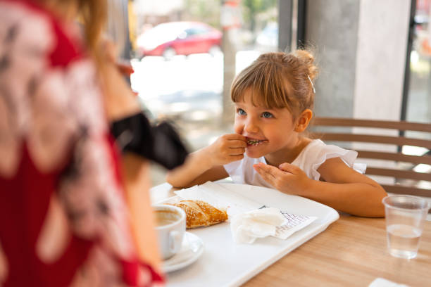 istock A cute little girl in the cafeteria 1404706620