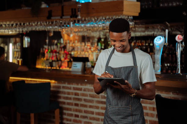 istock African American waiter working in restaurant on digital tablet 1404706669