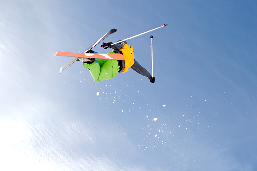 Freestyle skier doing a cork 720 on a backcountry jump at Valdresflya, Norway.