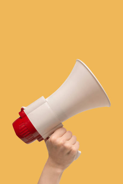 istock Megaphone in woman hands on a white background. 1404708243