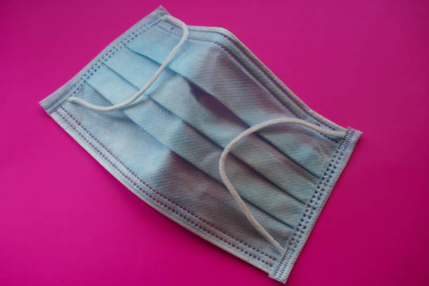 istock Medical mask close up on a pink background. 1404710444