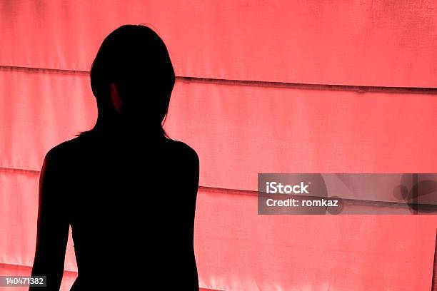 Silhouetted View Of Woman Standing At Red Light District Stock Photo - Download Image Now