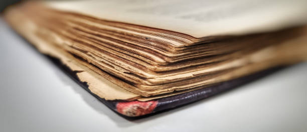 istock OLD RED BOOK WITH YELLOWED PAGES FROM THE PASSAGE OF TIME 1404714344