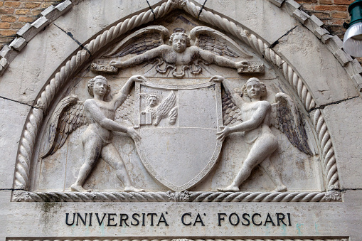 Venice, Italy - 06 09 2022: Stone crest of the University of Foscari in Venice on a summer day.
