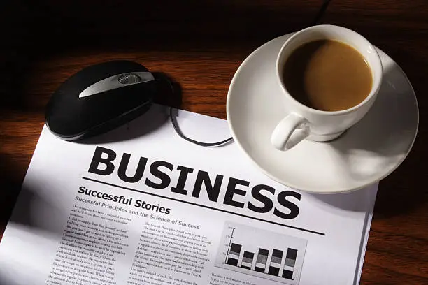 Still life of coffee, mouse and business file on table