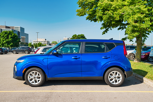 A blue colored Kia Soul is parked in a parking lot in Burlington, Ontario, Canada on a sunny day.