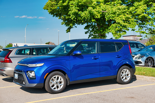 A blue colored Kia Soul is parked in a parking lot in Burlington, Ontario, Canada on a sunny day.