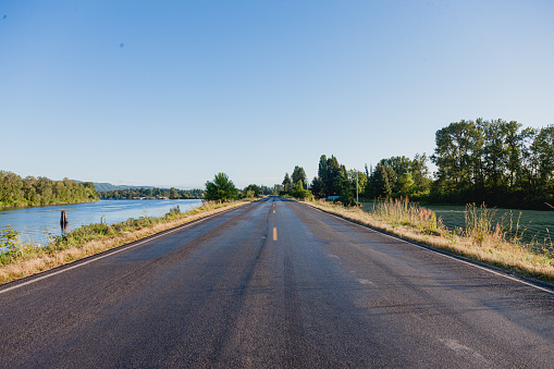An empty open road with no traffic on it, in a rural scenic area in the Pacific Northwest. Shot in the morning during the summer months in Oregon.