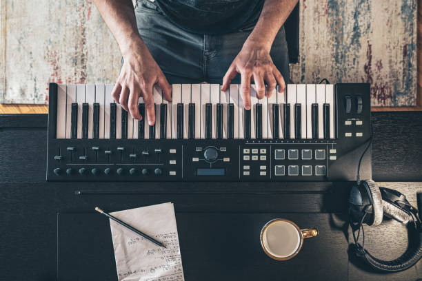 Male hands on the piano keys, top view. Male musician creates music, top view, piano keys. keyboard instrument stock pictures, royalty-free photos & images