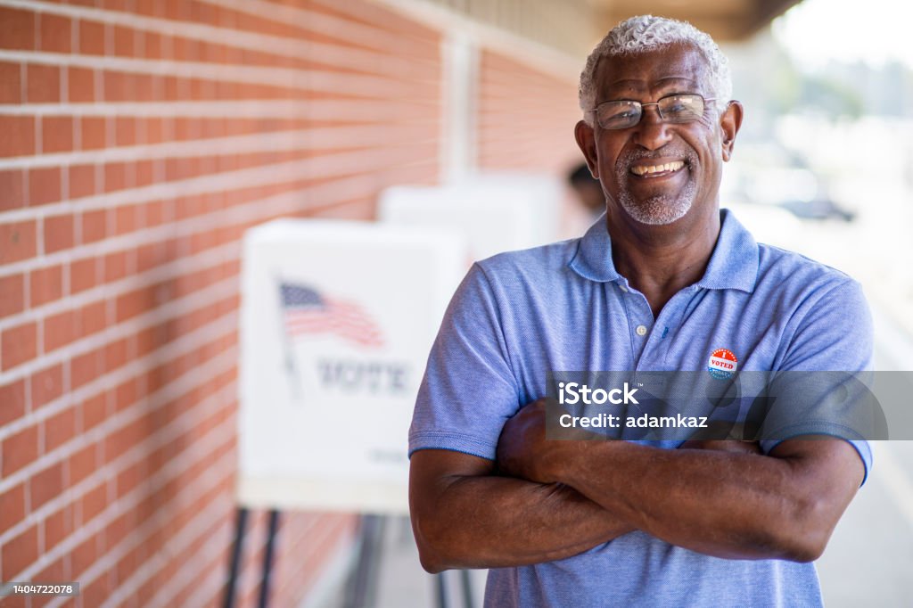 Senior Black Man with I voted Sticker A senior black man with his I voted sticker after voting in an election. Voting Stock Photo