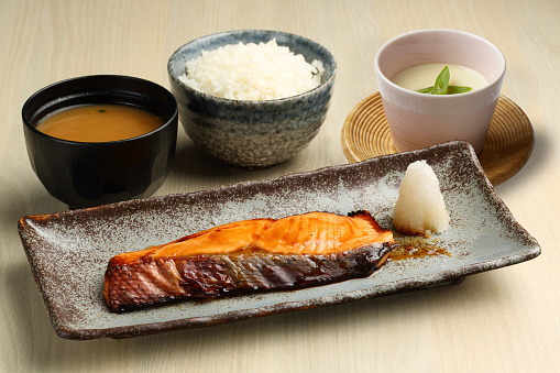 Salmon Teriyaki Set with miso soup and Chawanmushi served in a dish isolated on wooden table background side view of singapore food