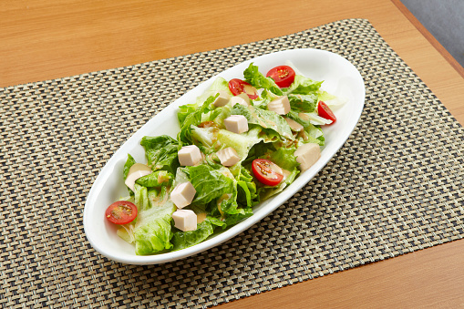 Tofu Salad served in a dish isolated on wooden table background side view of singapore food