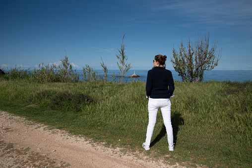 Woman Tourist Enjoying Seaside Air in the Morning on a Vacation in Greece