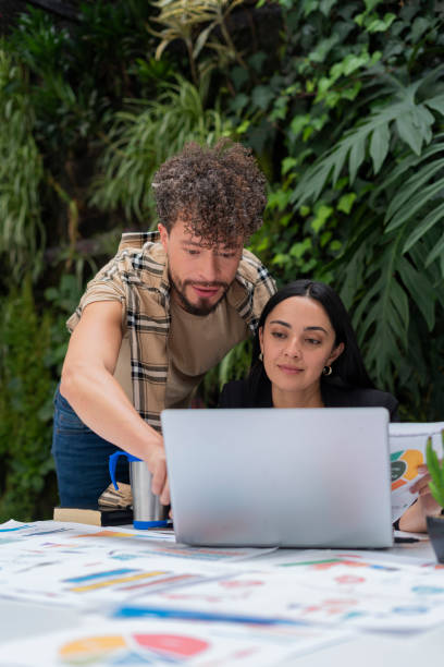 istock Fair-haired gay co-workers are in their office working on a business plan 1404723253