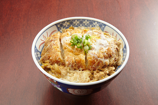 Katsu Don served in a dish isolated on wooden table side view of singapore food